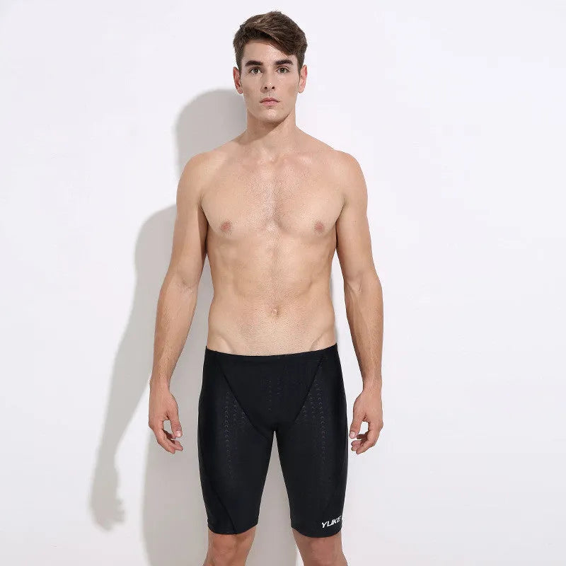 Men's black swimming set with trunks, anti-fog goggles, waterproof cap, ear plugs with nose clip, and carry bag