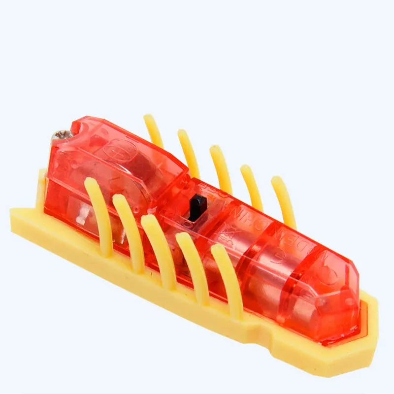 Small electric ladybird beetle cat toy with 12 walking legs on grey surface