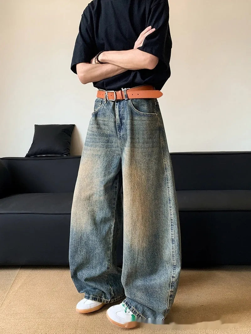 Men's distressed retro blue denim trousers with wide-leg silhouette and micro-elastic cotton-blend fabric