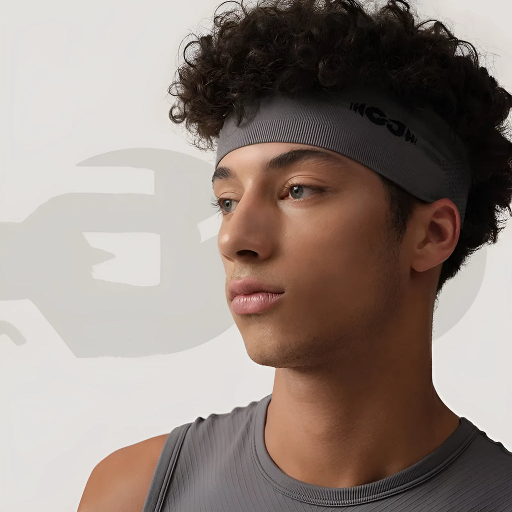 Seamless knitted exercise sweatband in black, shown flat, suitable for running and cycling.