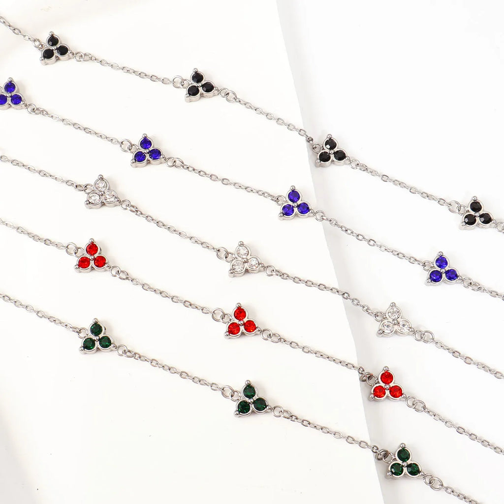 Women's stainless steel geometric bracelet with triangle design and coloured zircon stones.