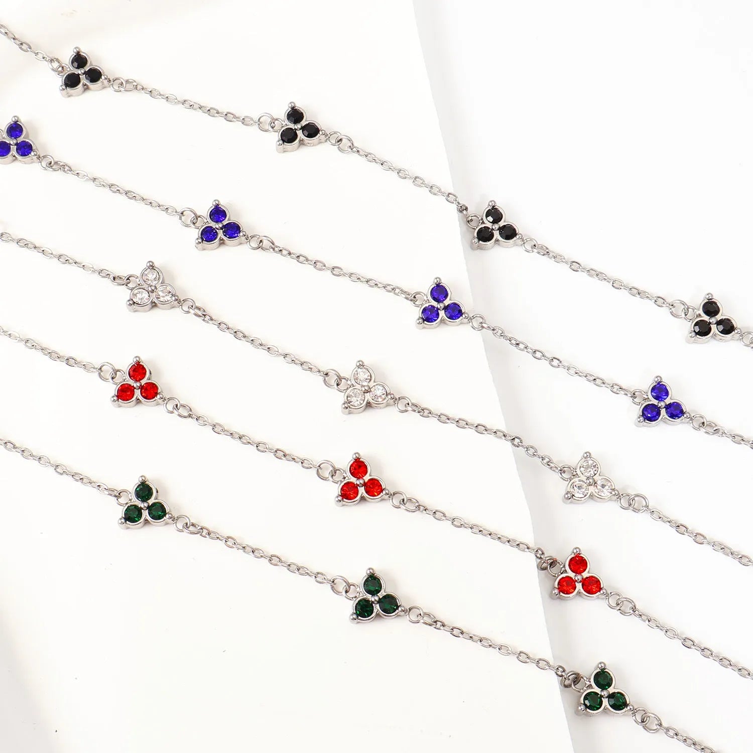 Women's stainless steel geometric bracelet with triangle design and coloured zircon stones.