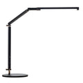 Aluminium LED desk lamp with clip base and remote control on a wooden desk.