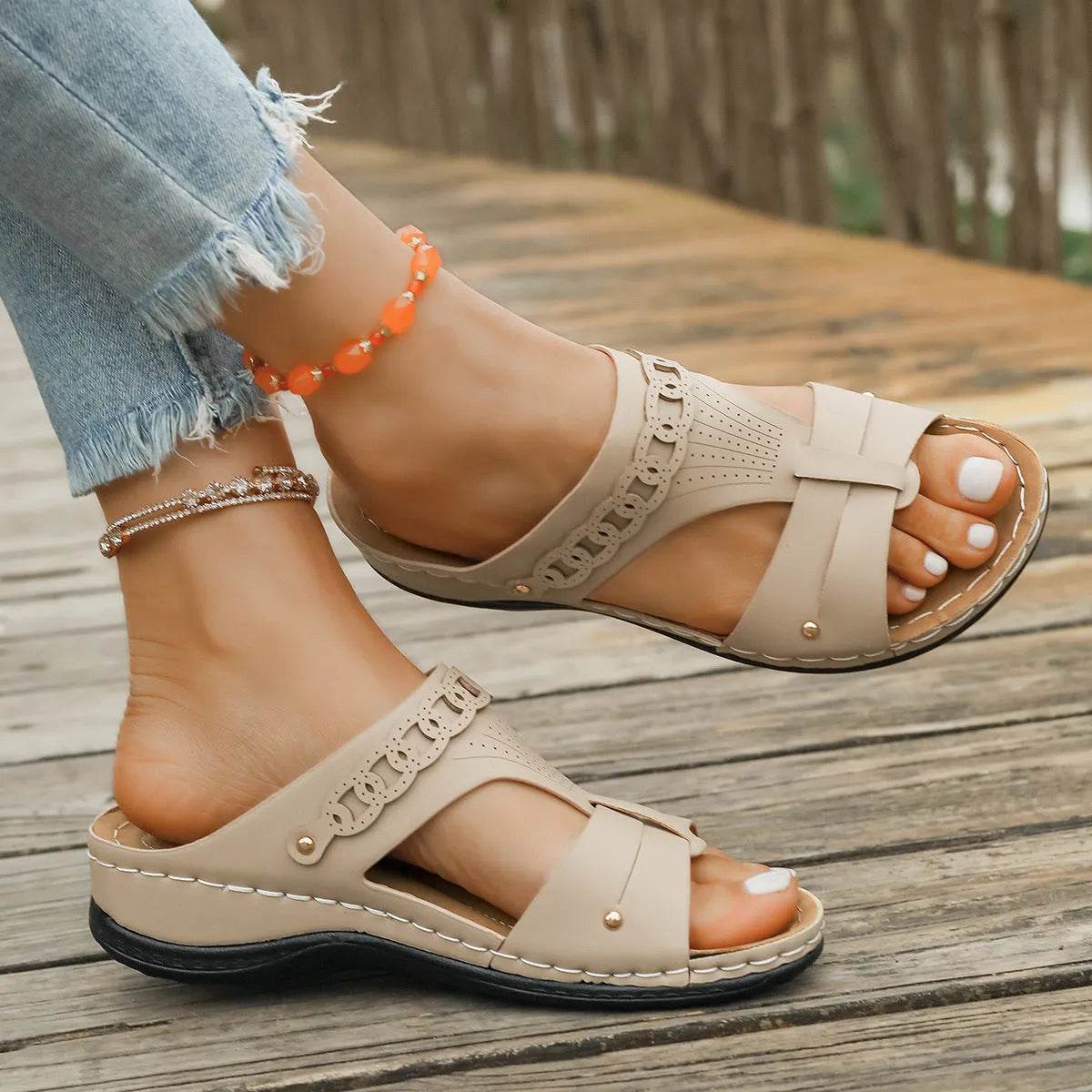 Casual blue Roman style slippers on a white background, showing slope heel and fish mouth toe design.