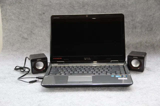 Black square USB-powered 2.0 mini desktop computer speakers on a desk