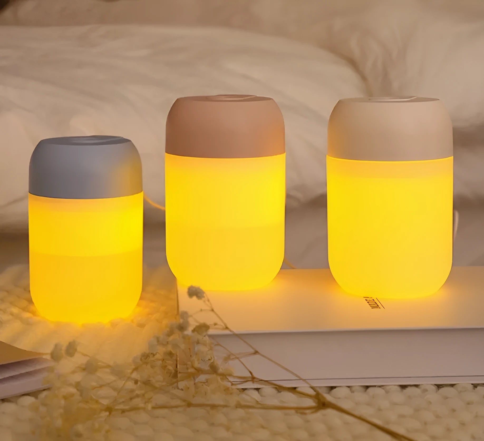 White cylindrical mini USB humidifier on wooden surface with charging cable