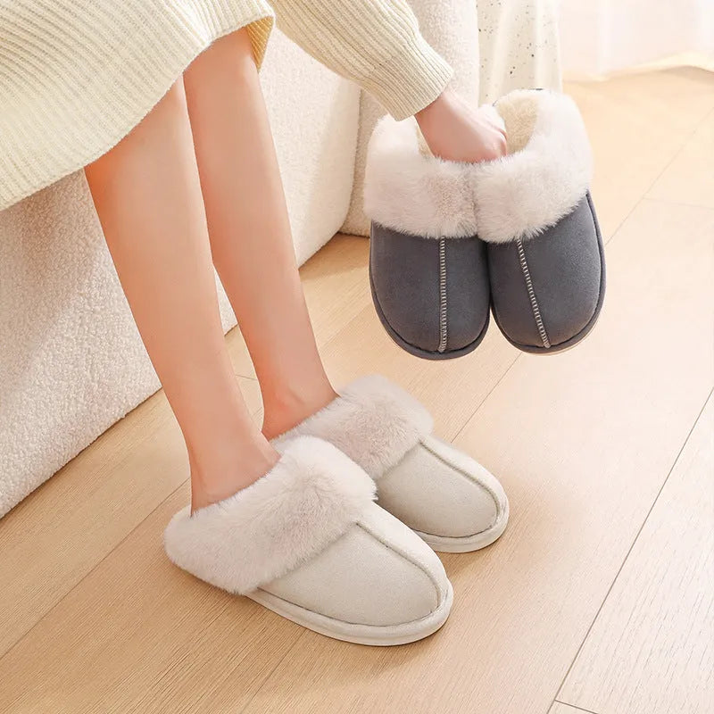 A pair of round-toe flat-heel plush slippers with stitching detail, shown in one of five available colours.