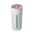 Black portable car humidifier with colourful LED lights showing mist output, placed in vehicle cup holder