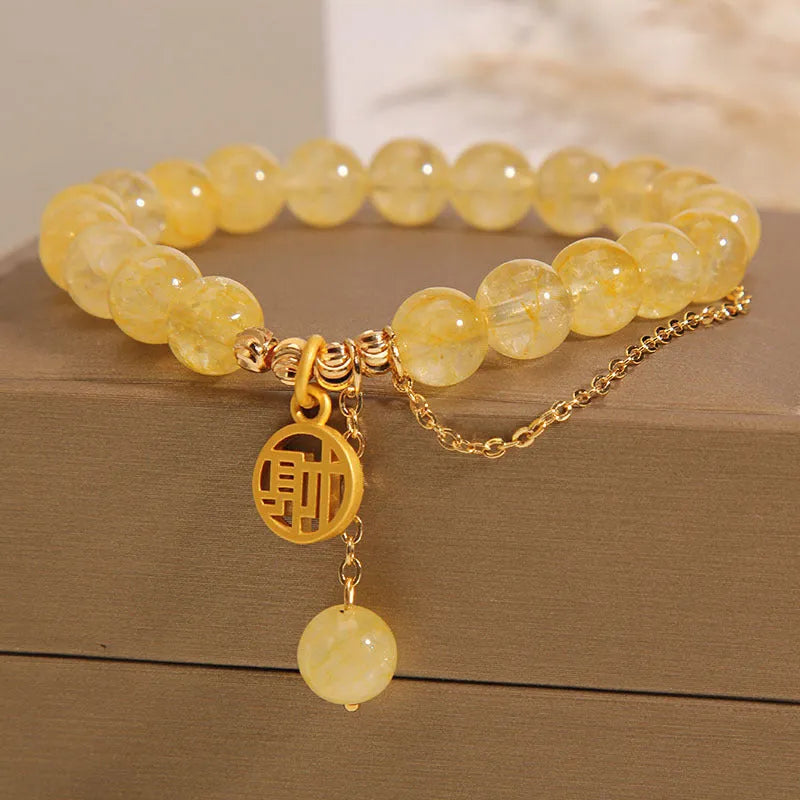 Natural citrine bracelet with Chinese character design and tassel detail