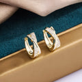 Geometric copper earrings with 14K yellow zircon finishing, showing architectural jewellery design