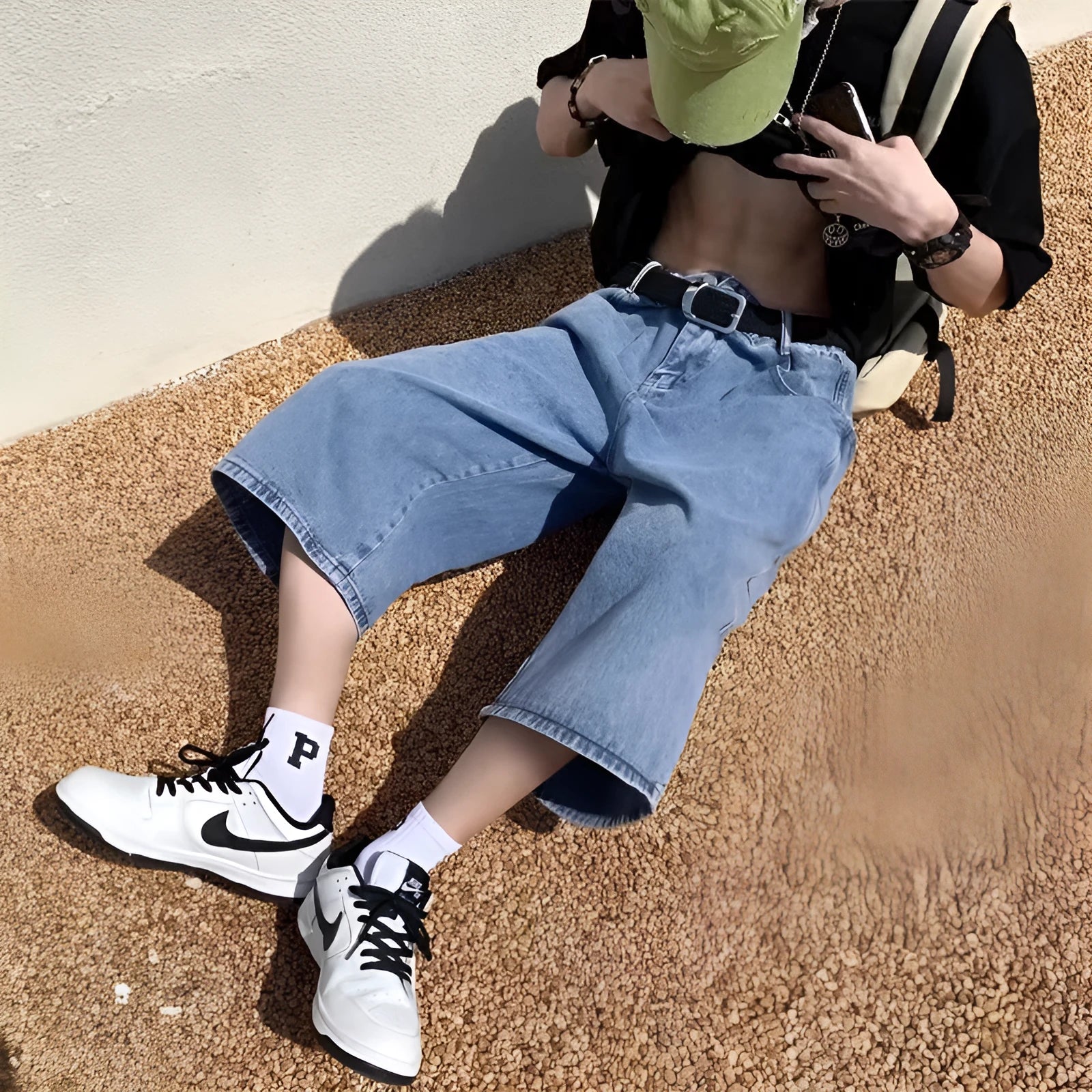 Blue men's washed denim pirate shorts with a high waist and cropped length on a neutral background.
