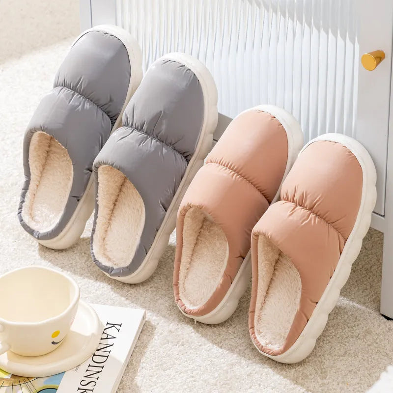Blue winter slippers for indoor use with a thick rubber non-slip sole and artificial plush lining.