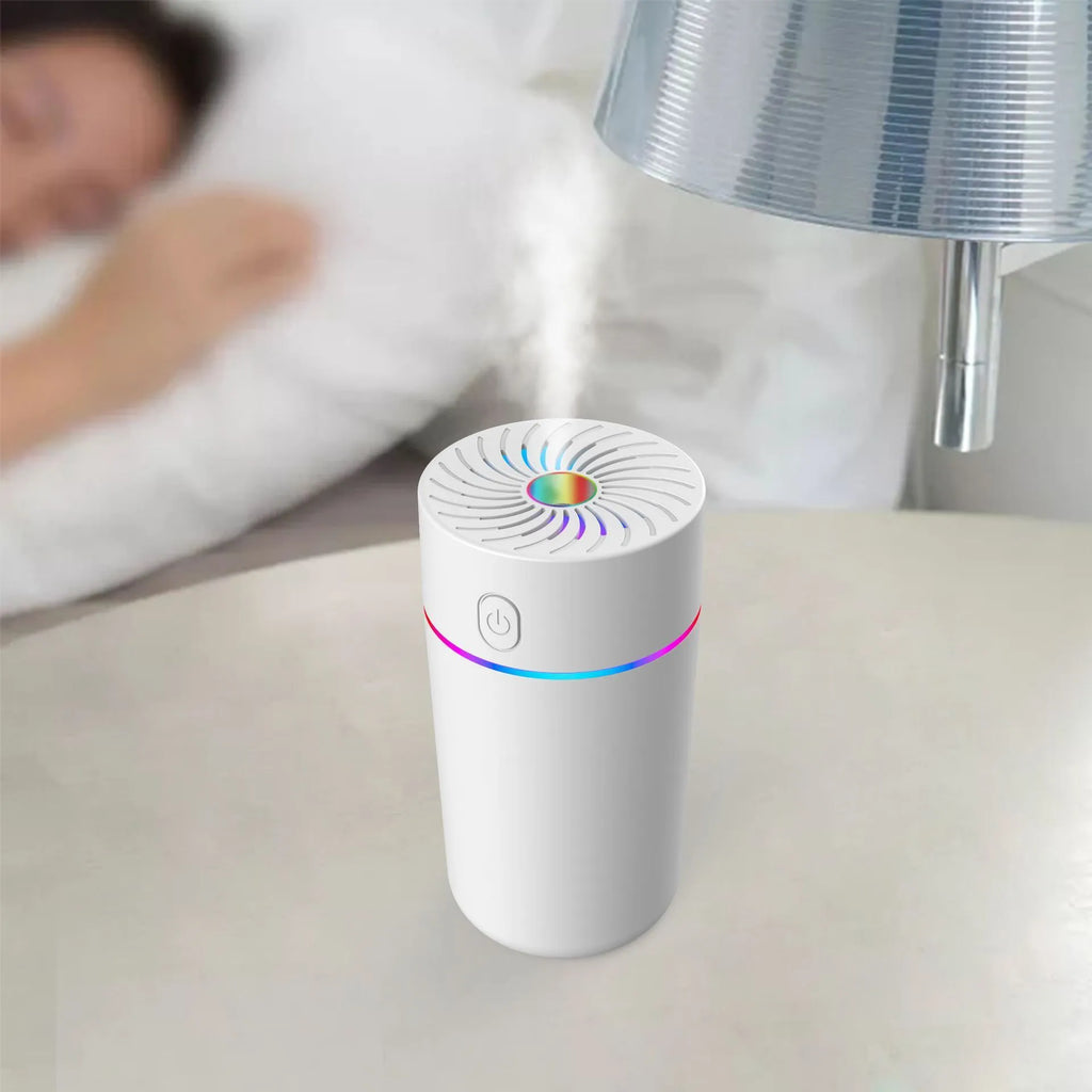 Compact white car USB mini humidifier with aromatherapy function positioned in vehicle cup holder