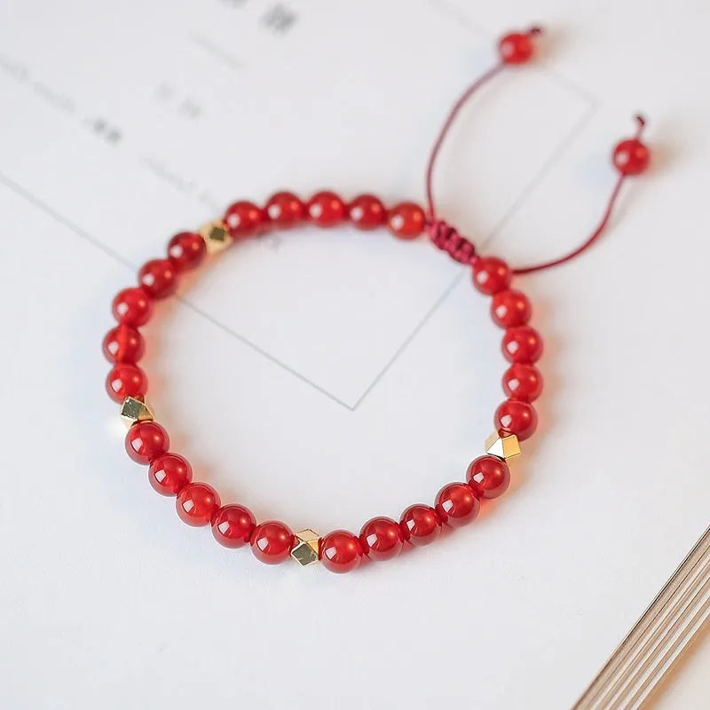 Natural red agate hand-woven bracelet showing diamond-shaped beads in ethnic woven pattern