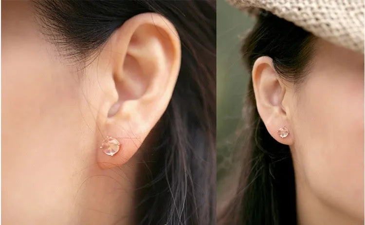 Rose gold coloured drop-shaped stud earrings with a synthetic ross quartz crystal inlay
