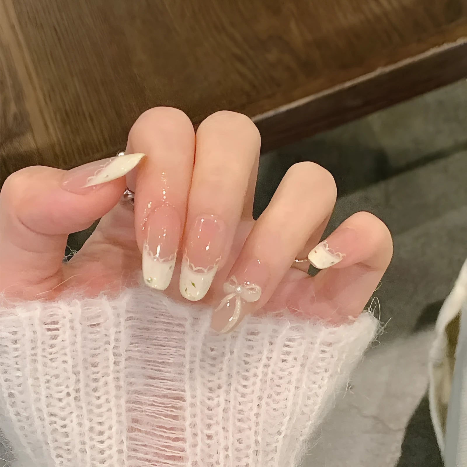 A pack of five pairs of long square-shaped false nails in assorted colours and patterns.
