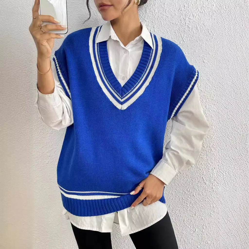 Blue loose-fit women's acrylic blend vest sweater on a hanger, college style.