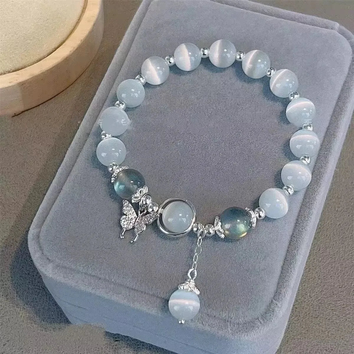 Glass butterfly bracelet for women with drop shape design and round beads in moonlight gray colour