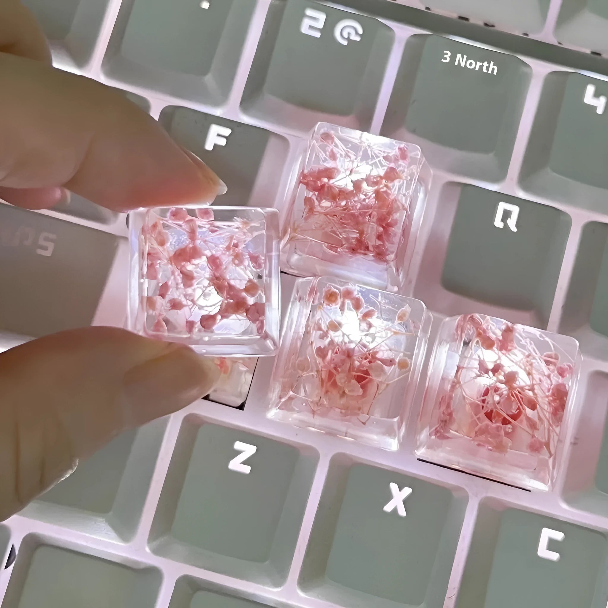 Transparent resin mechanical keyboard keycap with starry sky design in one of four colour options
