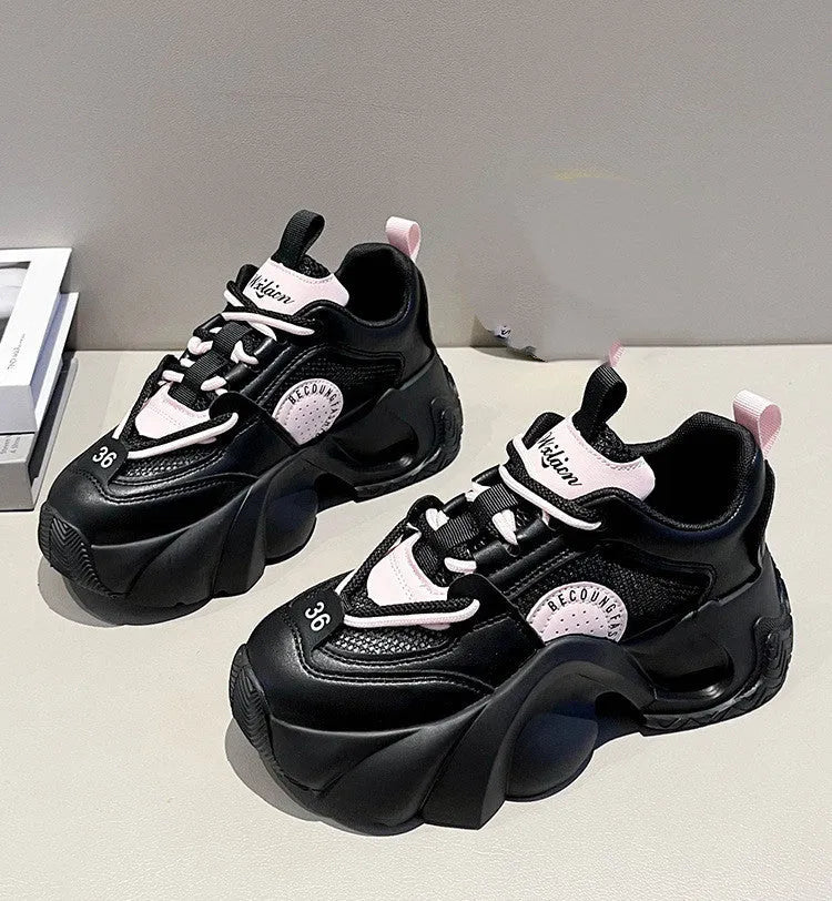 Women's pink casual sneakers with cross shoulder straps and a thick platform sole.
