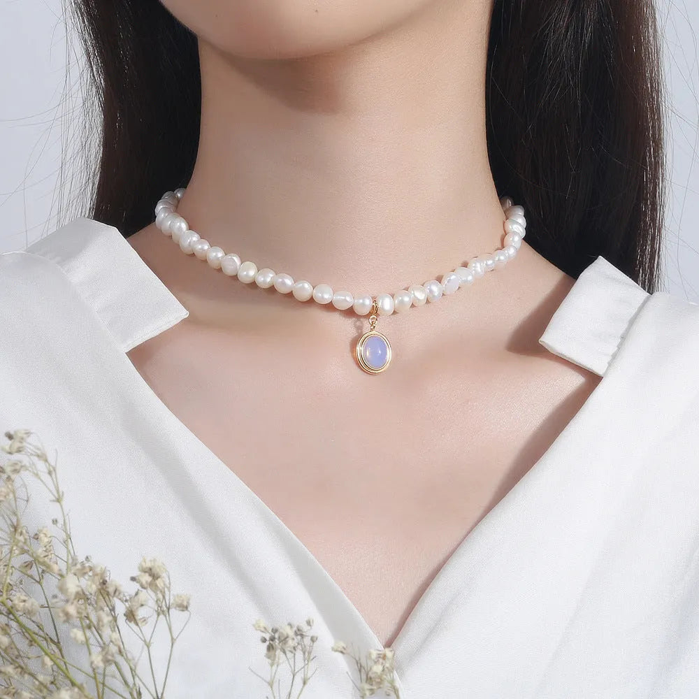 Silver necklace with round medal pendant and irregular pearl charm on adjustable 21-50cm chain