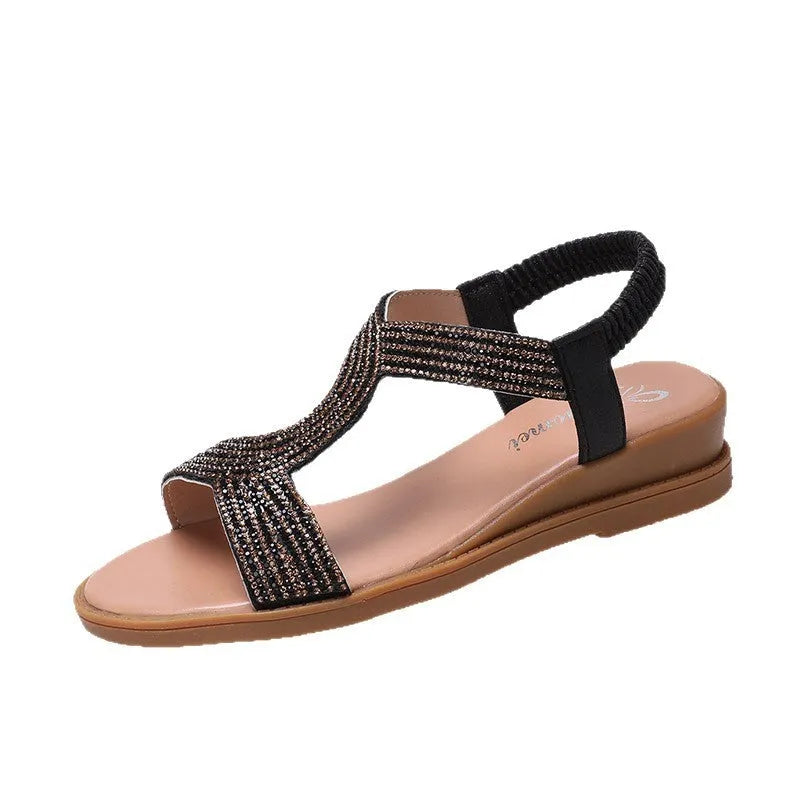 Gold women's patent leather sandals with rhinestone decoration on the strap and a non-slip sole.