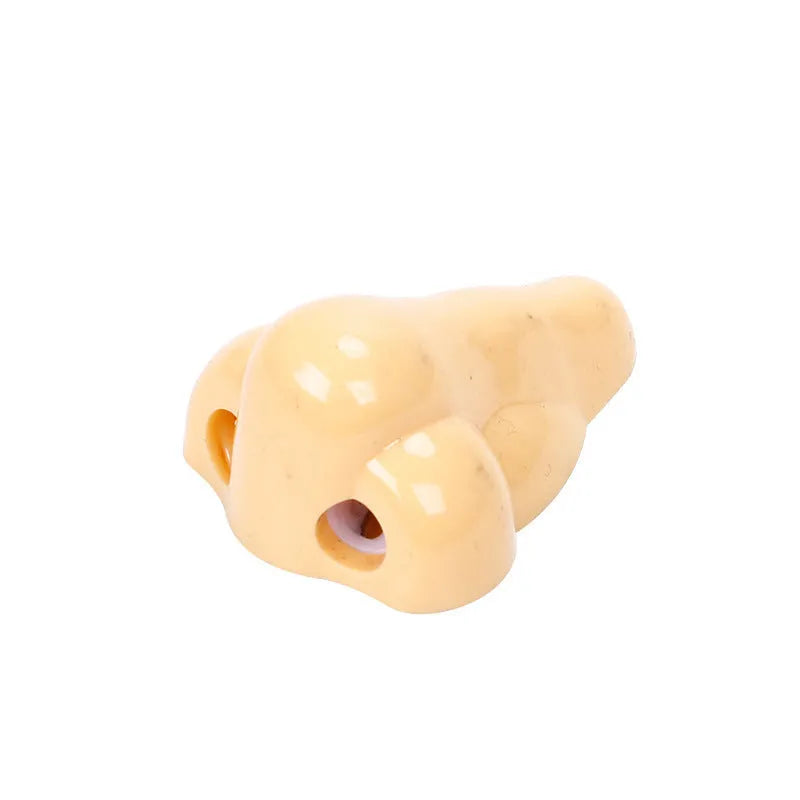 Flesh colour plastic student pencil sharpener with large nostril hole showing geometry shape