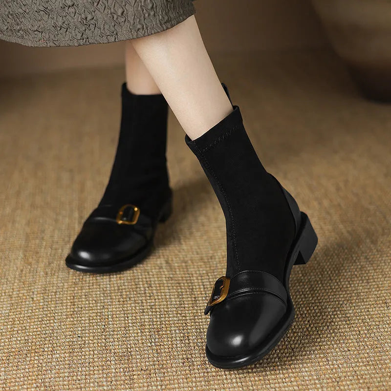 Women's black low heel Martin boot with front lace-up and silver ankle buckle on a round toe.