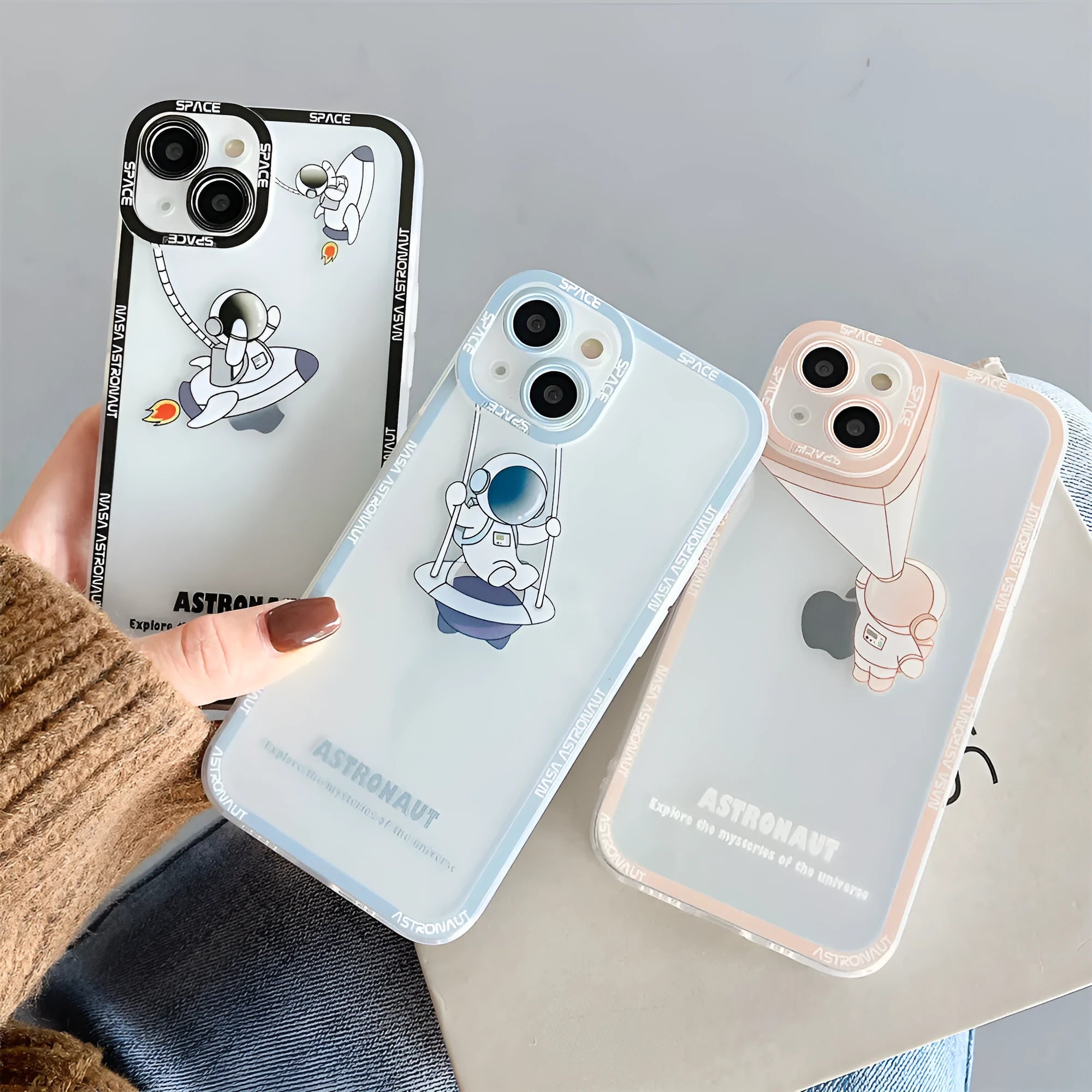 Clear silicone phone case with blue astronaut print, shown fitted on an iPhone.