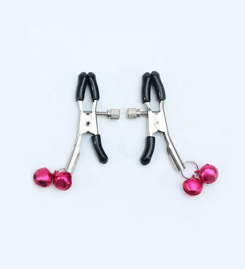 Red bell nipple clamp pair with chain attachment on a dark background