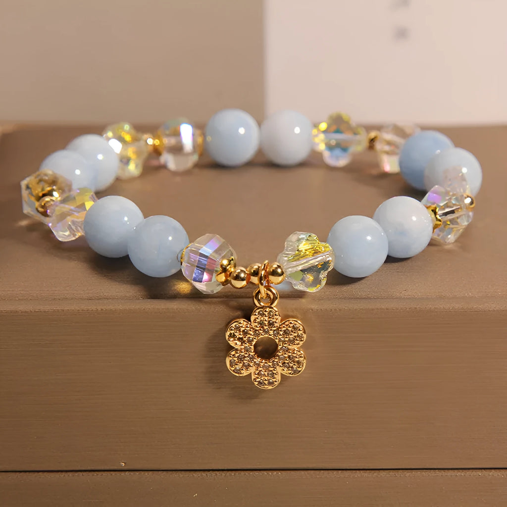 Women's aquamarine crystal bracelet with a four-leaf clover charm and pearl decorative accents