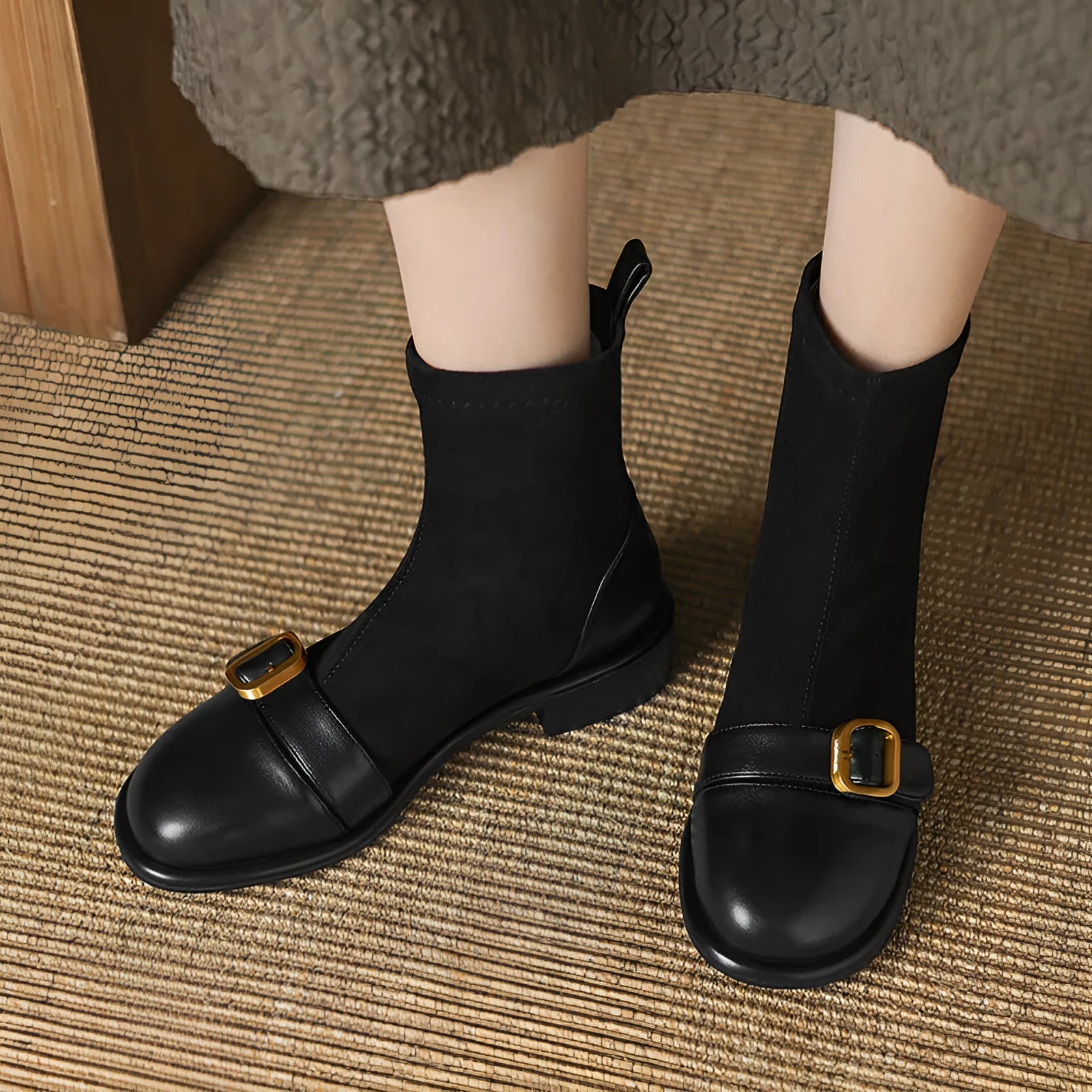 Women's black low heel Martin boot with front lace-up and silver ankle buckle on a round toe.