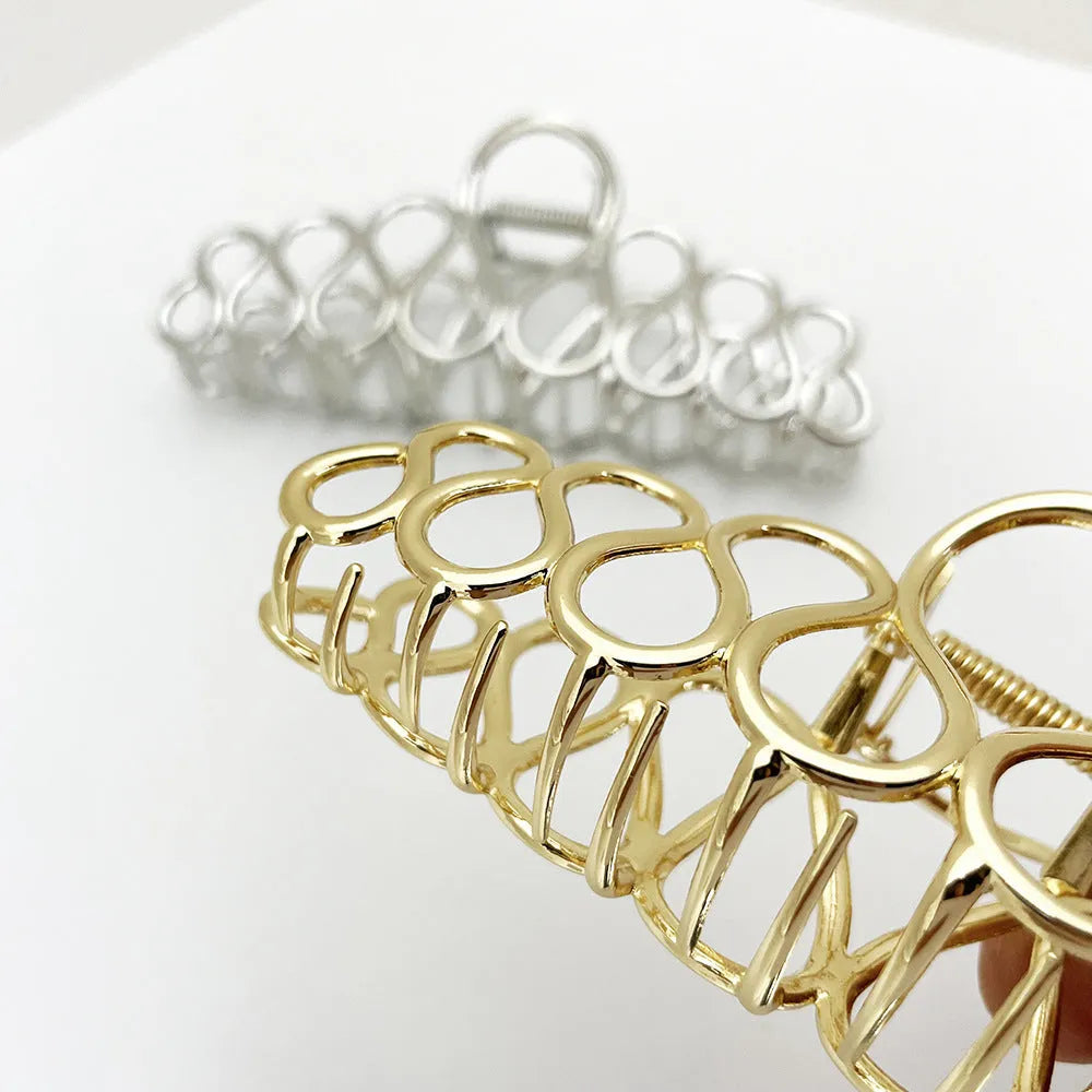 Women's minimalist hair clip in gold or silver with geometric tassel decoration
