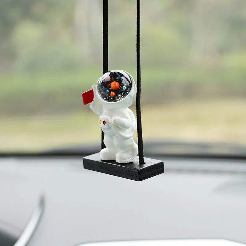 Resin astronaut car pendant showing five cartoon astronaut designs for vehicle decoration