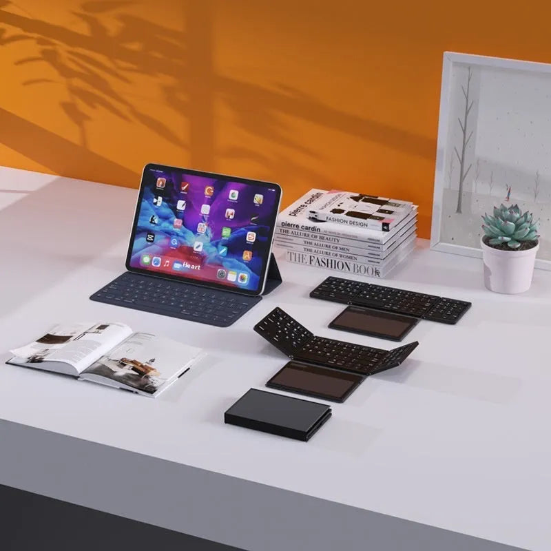 Black leather folding Bluetooth keyboard displayed against white background, folded and unfolded