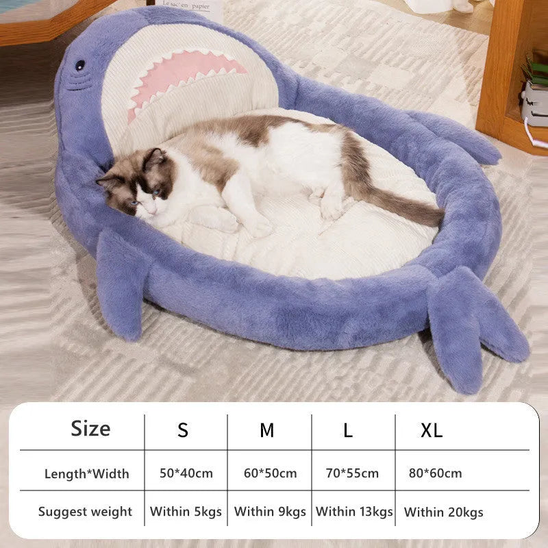 Blue shark pattern velvet pet bed cushion for dogs and cats on a wooden floor.