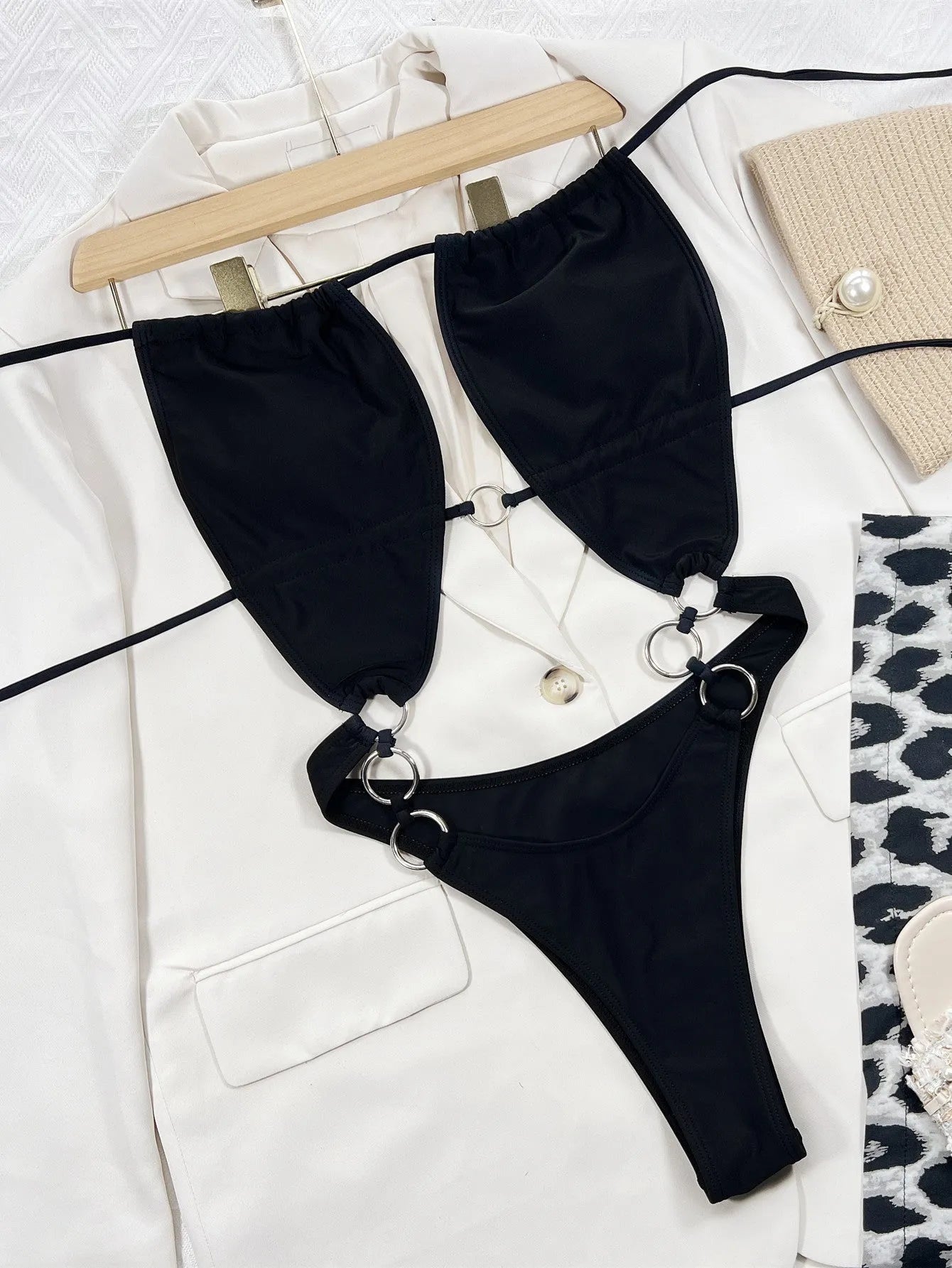 Black women's one-piece swimsuit with steel ring detailing and sleeveless design
