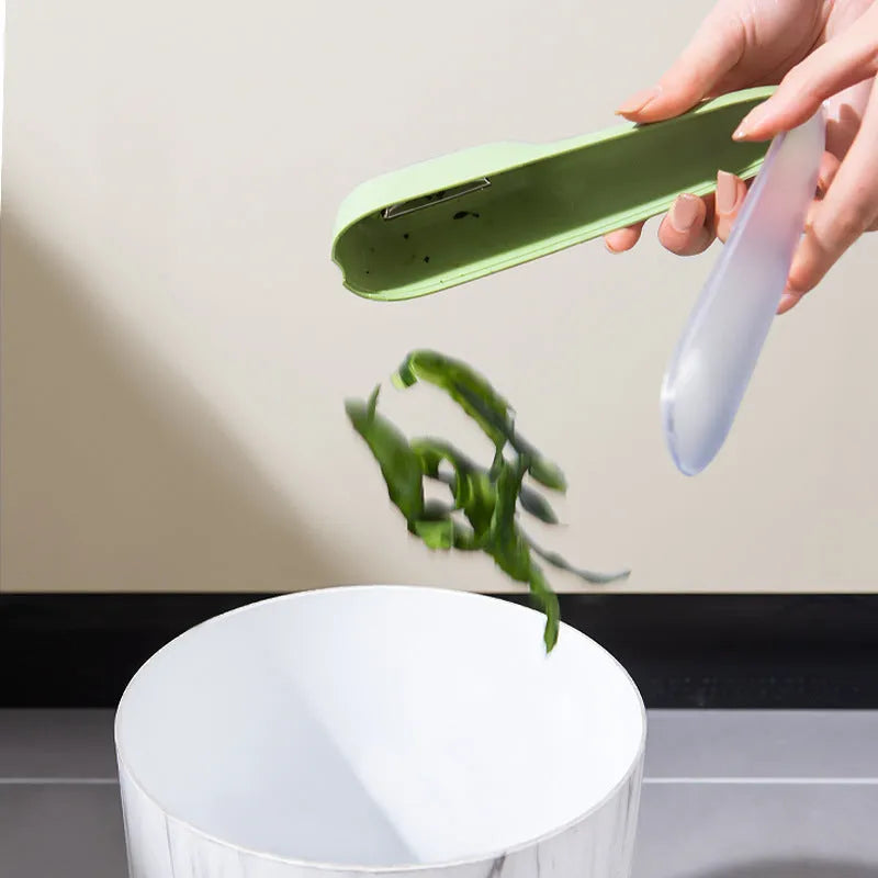 Dark green kitchen peeler with storage tube and stainless steel blade for peeling vegetables and fruit