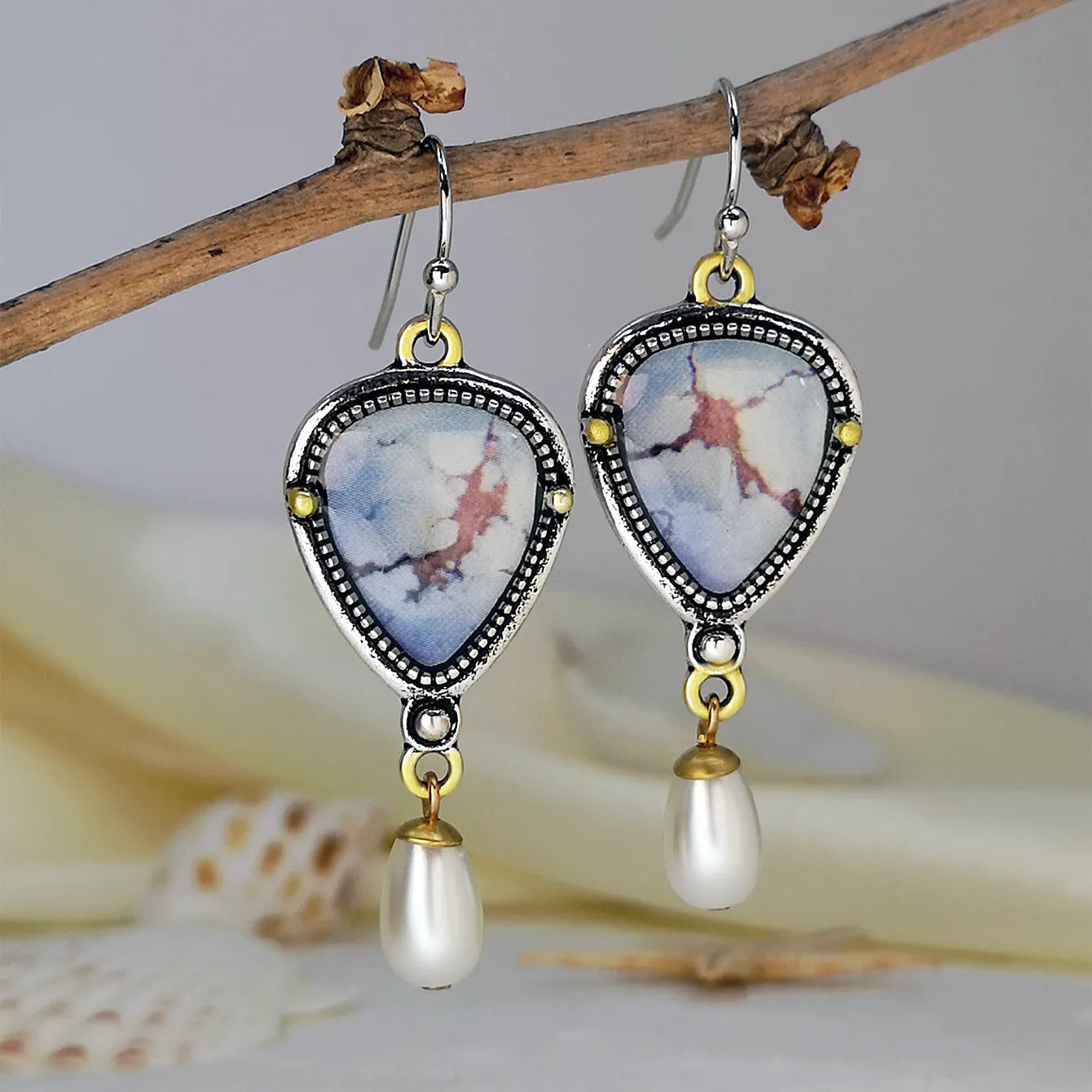 Retro blue geometric drop earrings with synthetic blue opal and white pearl on electroplated metal.