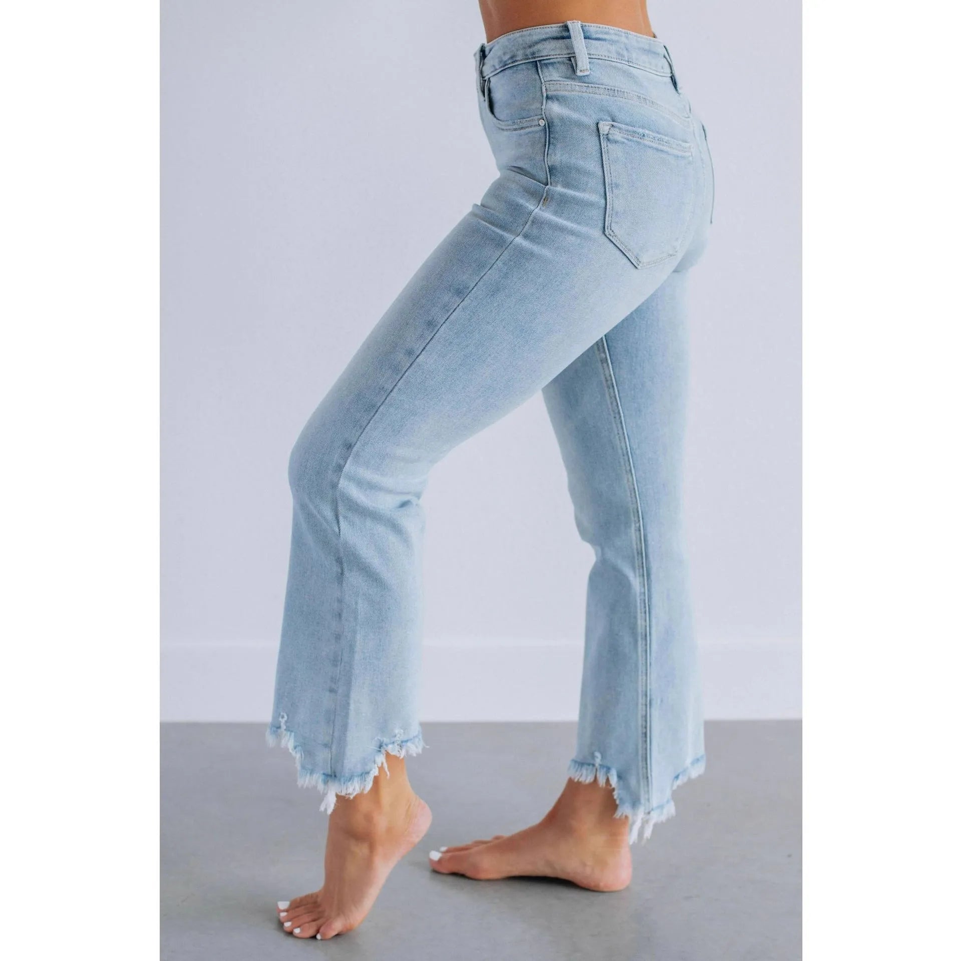 Women's solid colour denim jeans with a hand-worn finish, shown in dark blue and light blue.