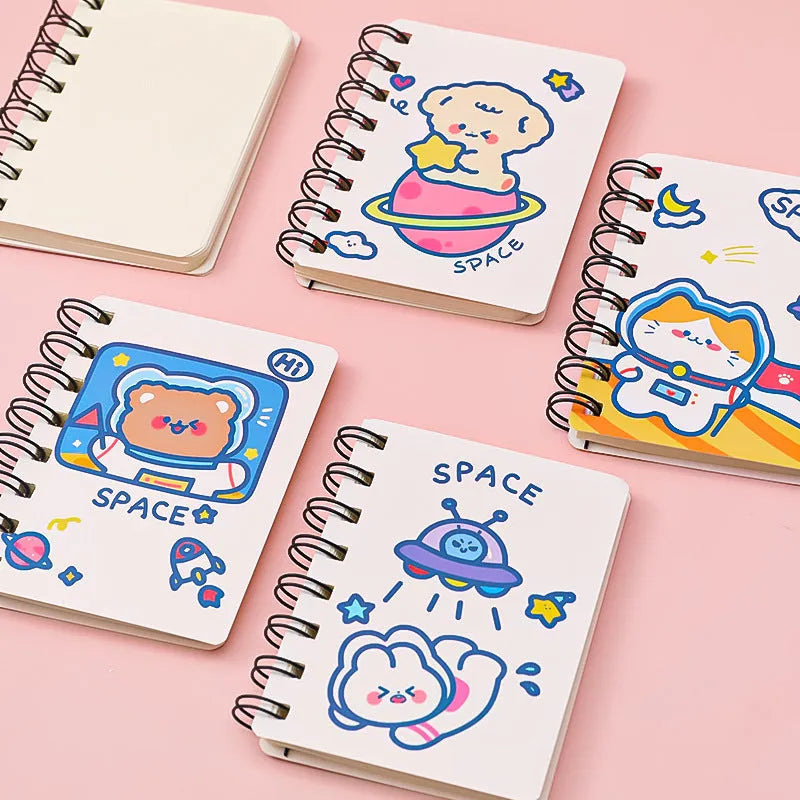 Small astronaut-themed flipper notebook showing one of four cover designs: Astronaut Bear, Planet Teddy, Space Cat, or UFO.