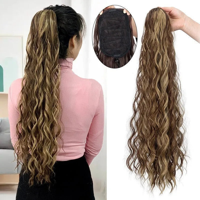 Long synthetic hair extension with water ripple curly texture in a dark colour, featuring a drawstring ponytail base.