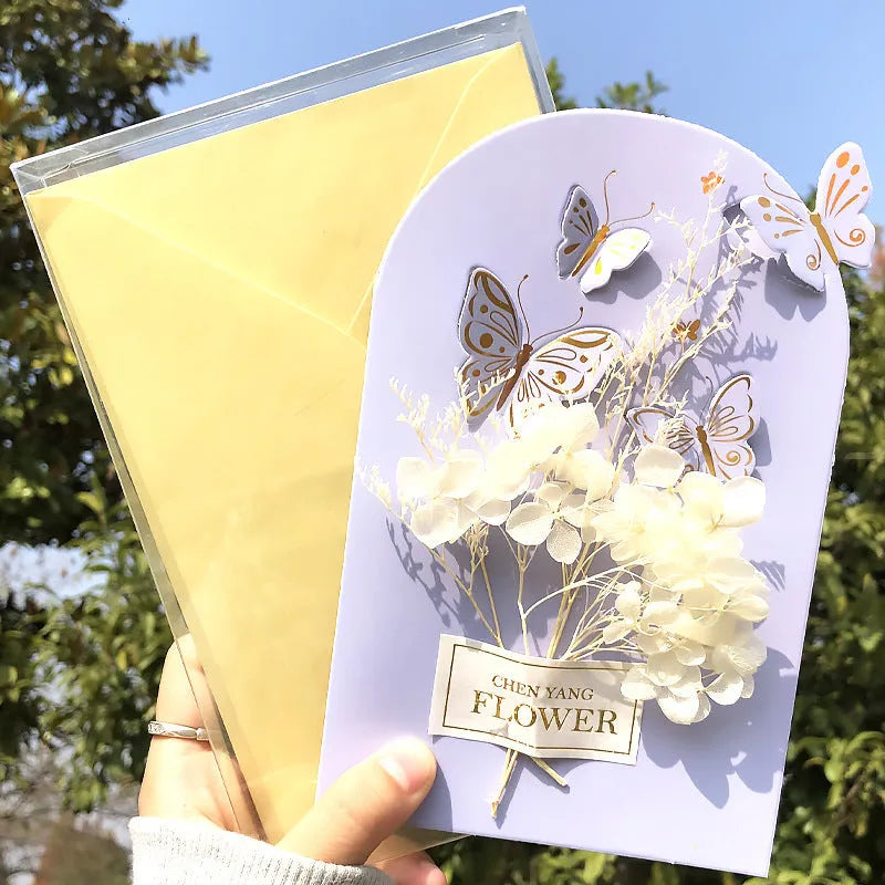 Handmade 3D butterfly-shaped birthday card with artificial flowers and hot foil stamping details.