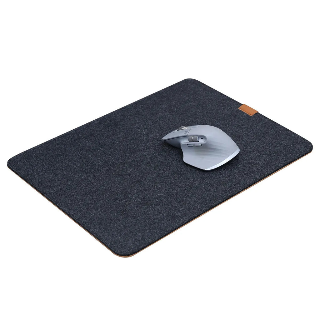 Simple grey felt and cork desk mat in an oversized rectangle shape on a wooden desk.