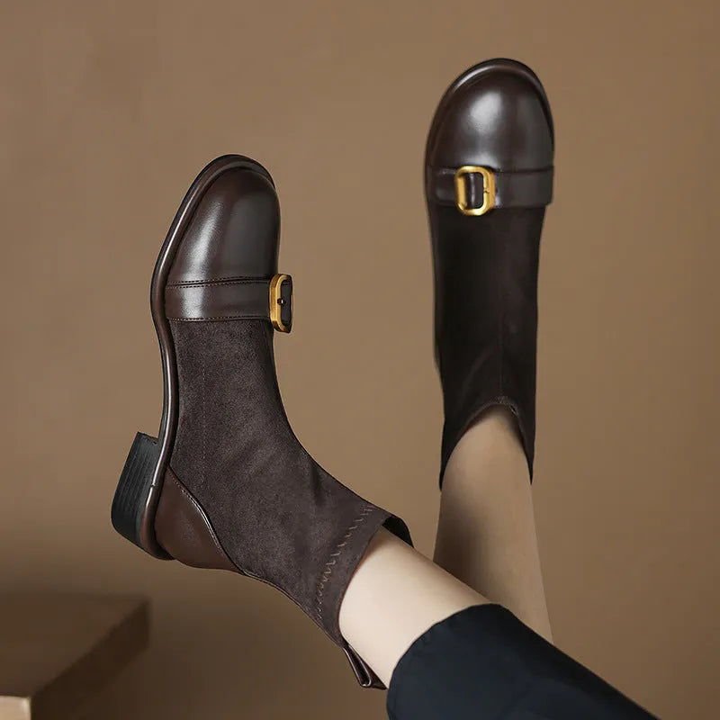 Women's black low heel Martin boot with front lace-up and silver ankle buckle on a round toe.