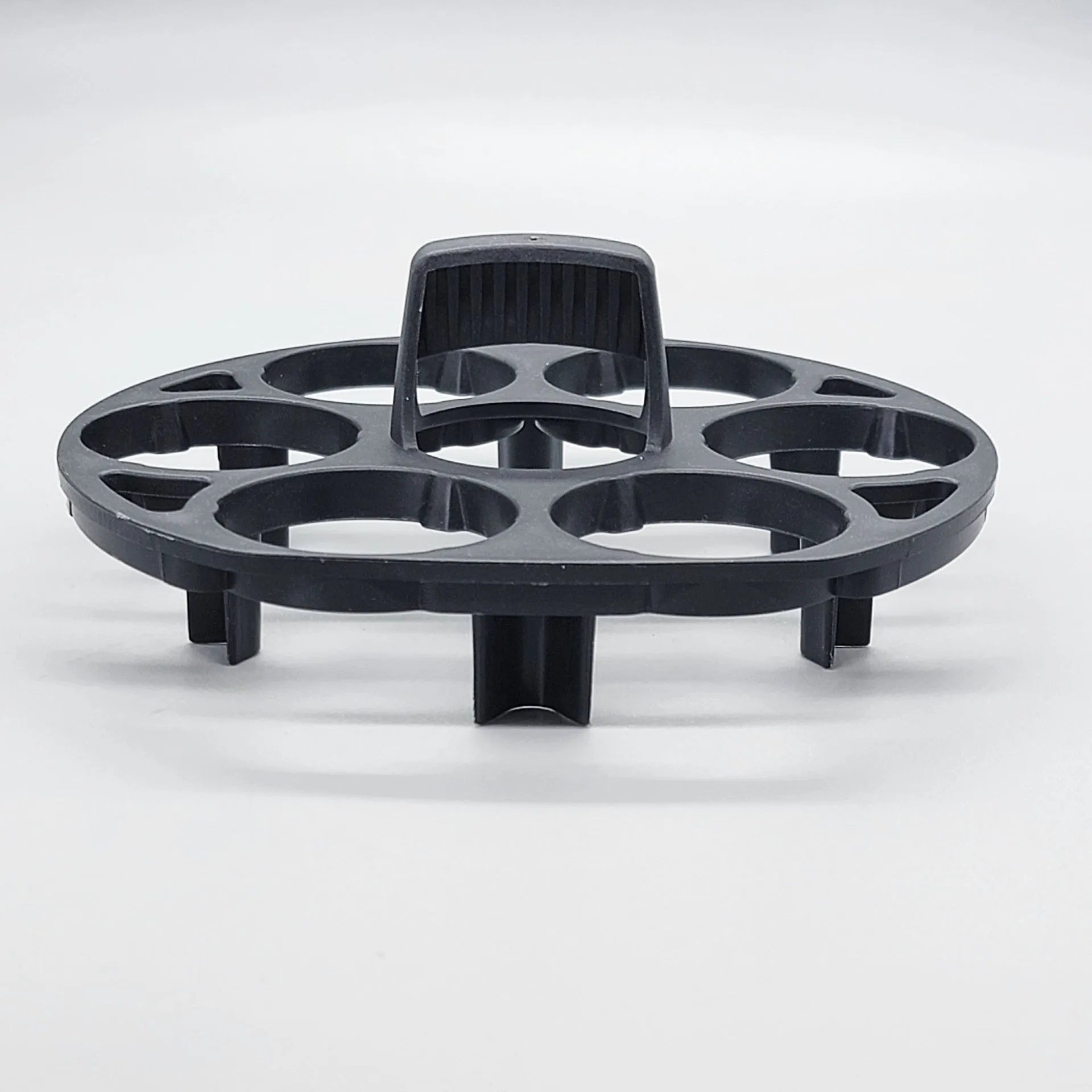 Black plastic egg holder basket for kitchen storage on a white background.