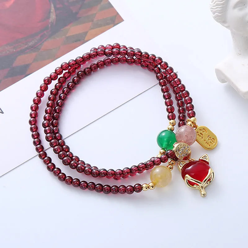 Purplish red garnet fox bracelet with adjustable rope closure and nature-inspired charm