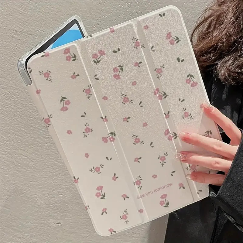 Transparent floral tri-fold iPad case with magnetic stand, showing cartoon print on clear PC hard shell.