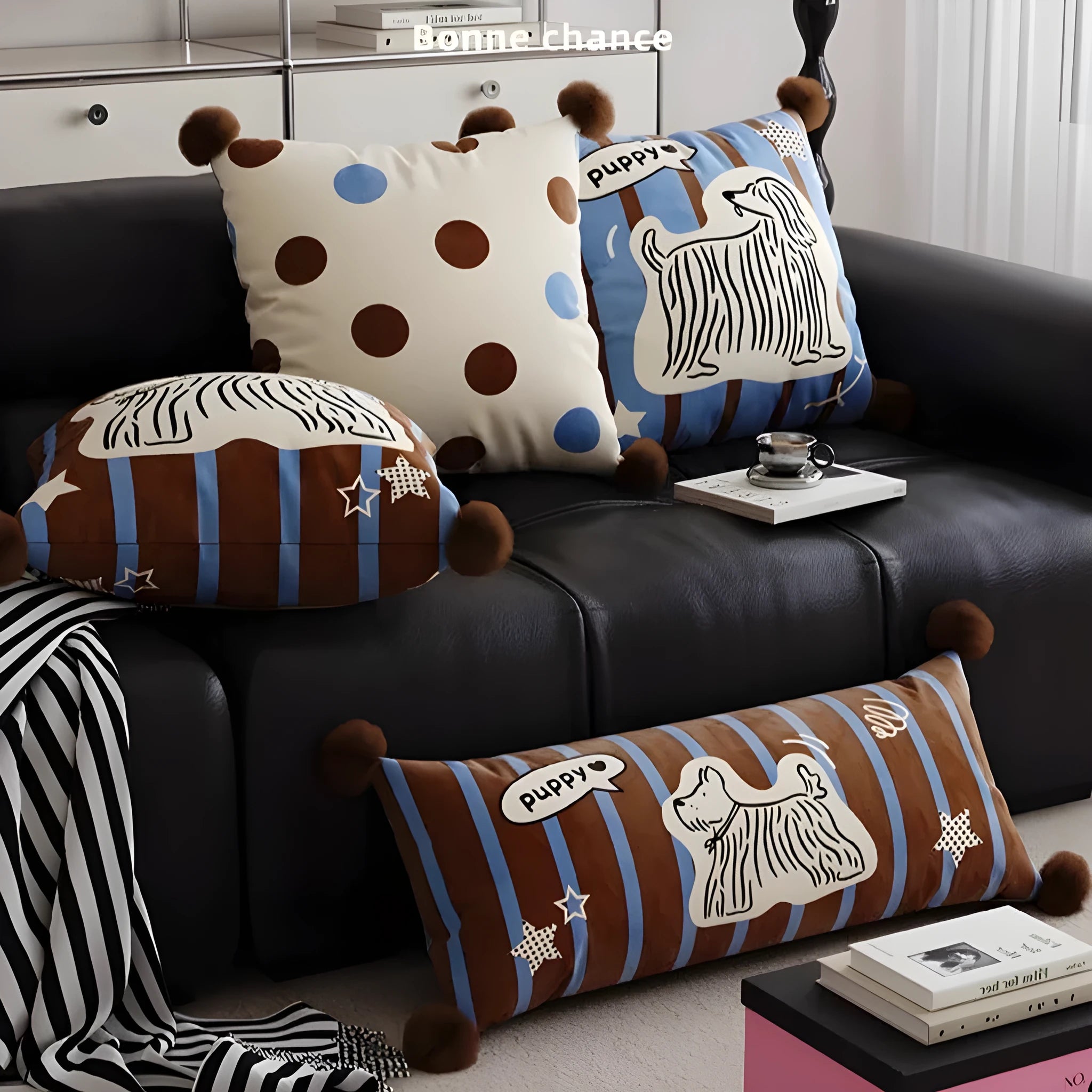 Blue cartoon animal print cushion pillow with removable cover on a grey sofa.