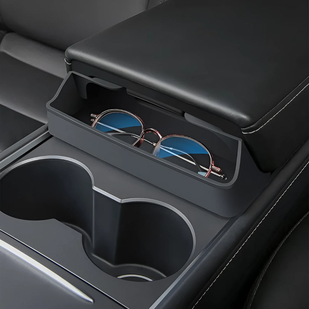 Black silicone sunglasses case mounted in Tesla centre console armrest compartment